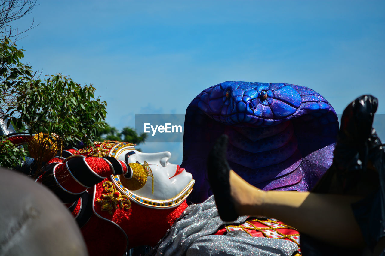 Close-up of sculpture lying on the ground against sky