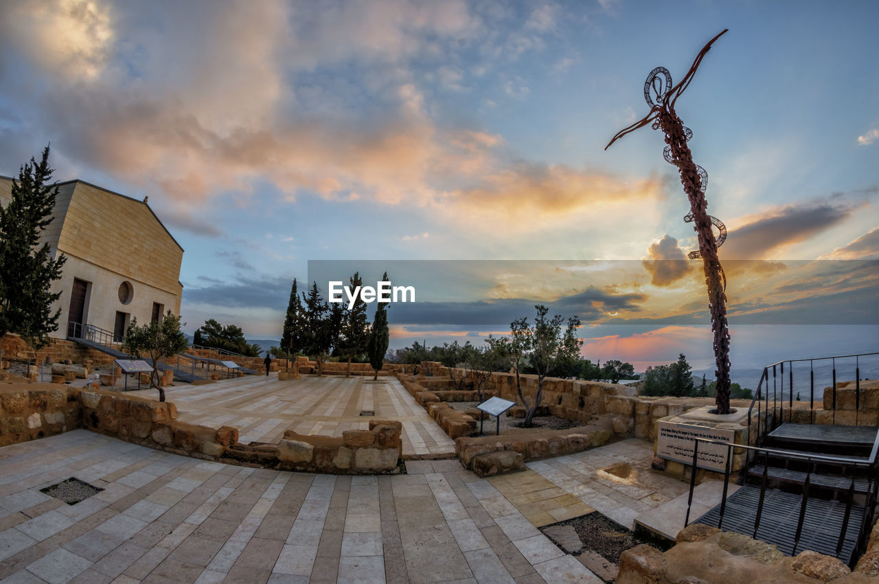 PANORAMIC VIEW OF BUILDING AND TREES AGAINST SKY