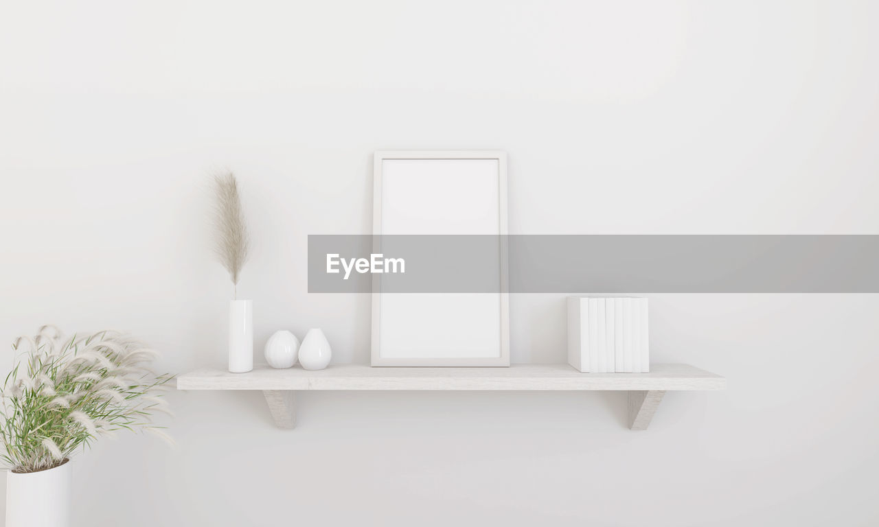 POTTED PLANT ON TABLE AGAINST WHITE WALL