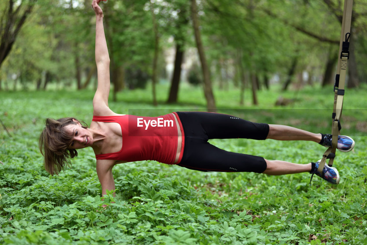 Mid adult woman exercising at public park