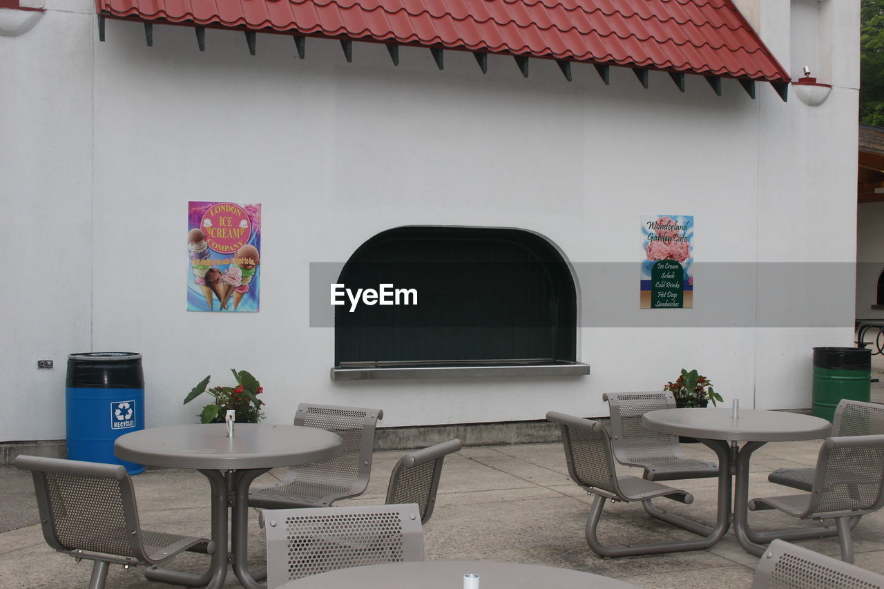 POTTED PLANTS ON TABLE BY BUILDING