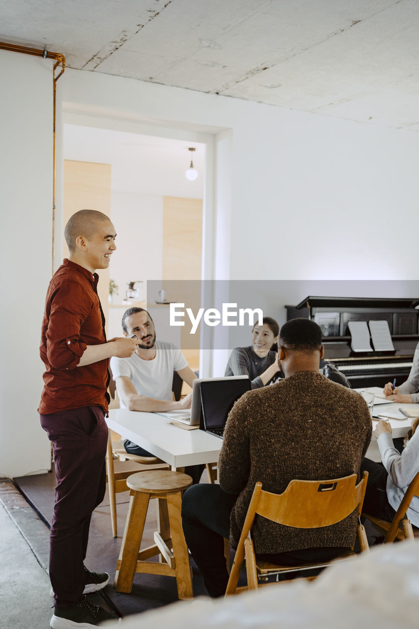 Male hacker presenting business idea during meeting at startup company