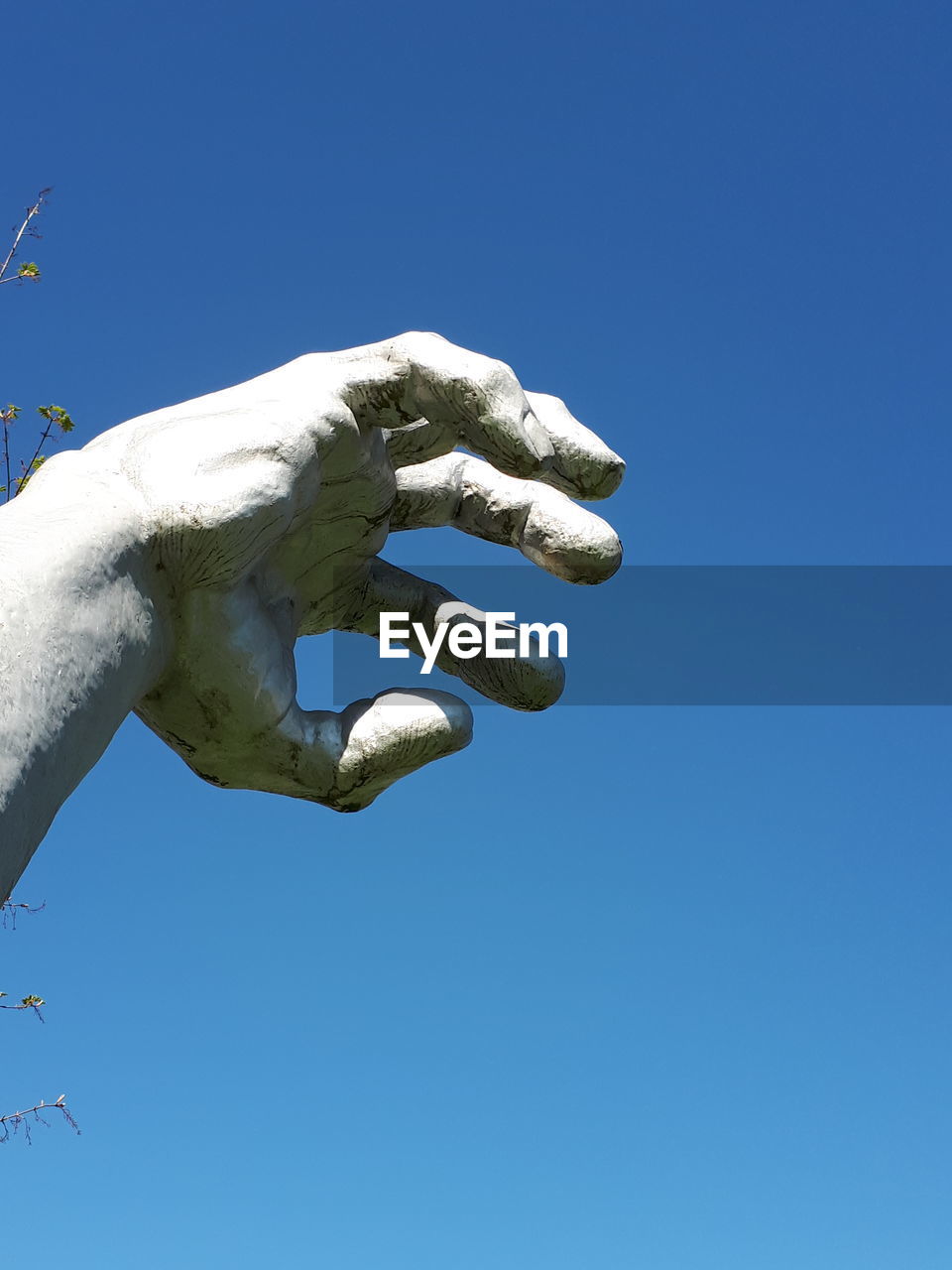 Low angle view of statue against clear blue sky