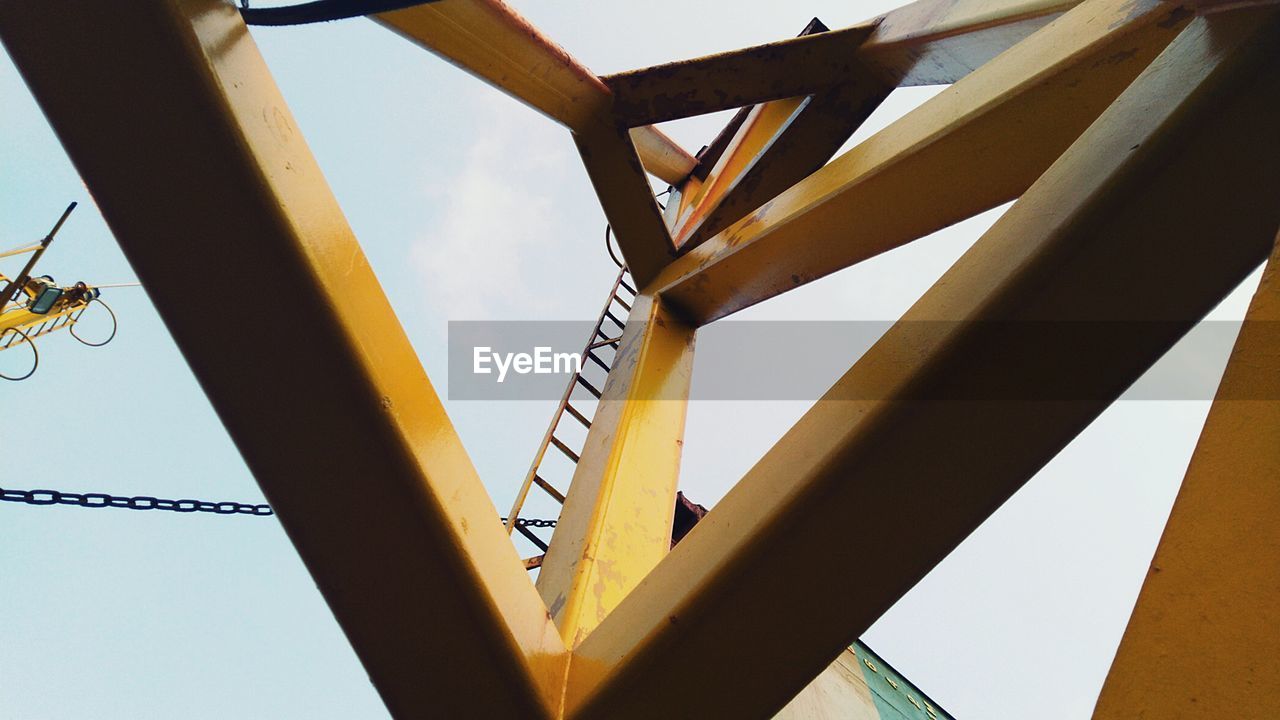 LOW ANGLE VIEW OF YELLOW BRIDGE AGAINST SKY