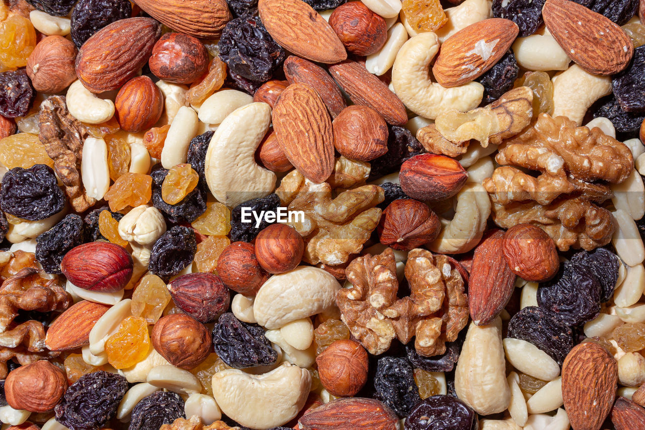 full frame, food and drink, food, dried fruit, large group of objects, backgrounds, nut, nut - food, produce, abundance, wellbeing, no people, healthy eating, almond, variation, still life, close-up, fruit, dried food, high angle view, brown, indoors, freshness, peanut - food, multi colored, walnut