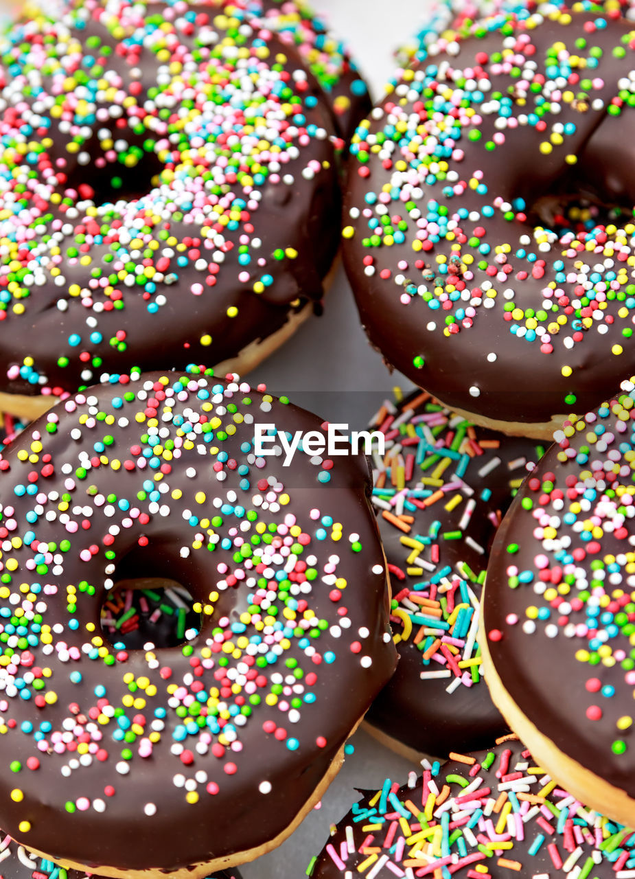 Chocolate donuts with chocolate shavings color on a traditional craftsman image.