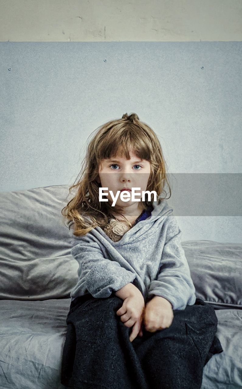 Portrait of girl sitting on floor