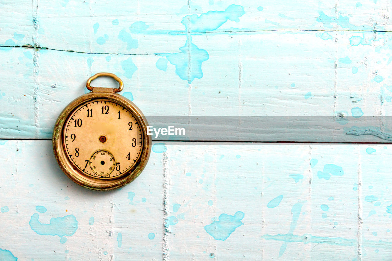 Directly above shot of old pocket watch on table