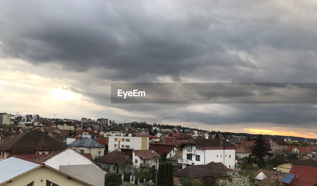 View of cityscape against storm clouds