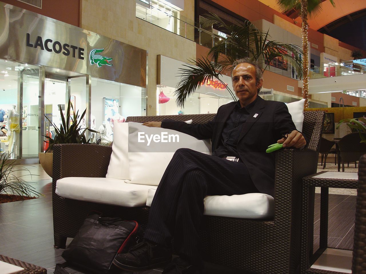 VIEW OF MAN SITTING IN OFFICE