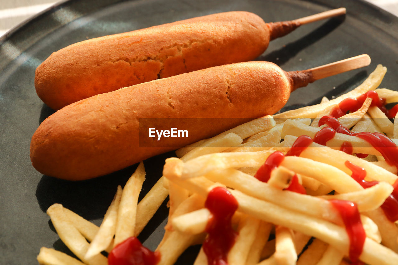 food, food and drink, dish, fast food, unhealthy eating, raw potato, meat, freshness, french fries, cuisine, no people, sausage, fried, produce, vegetable, indoors, still life, snack, close-up, hot dog, bratwurst, condiment, processed meat, high angle view, ketchup