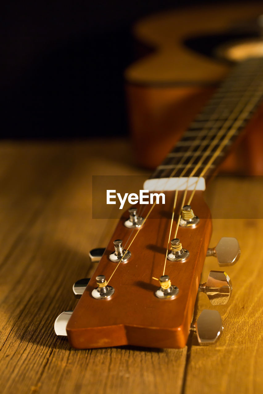 Close-up of acoustic guitar on table