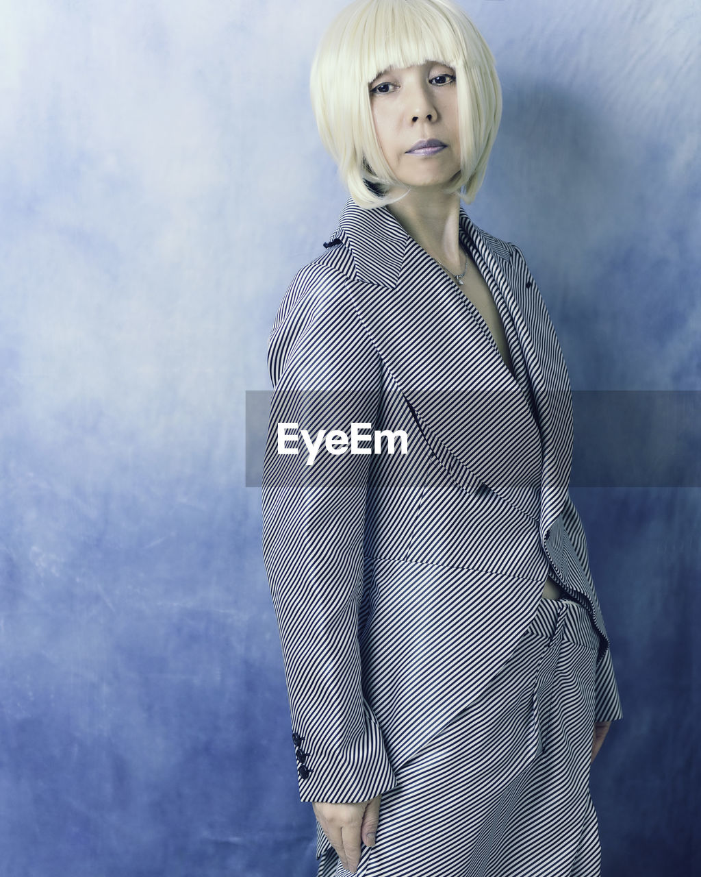 Portrait of woman standing against wall