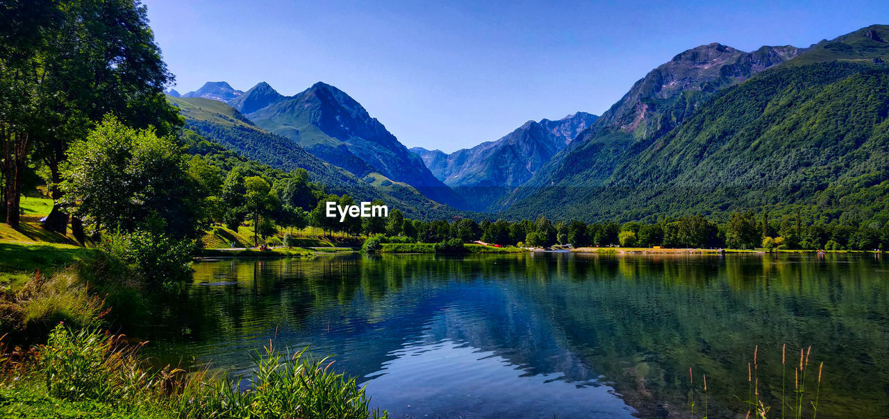 SCENIC VIEW OF LAKE AGAINST MOUNTAINS