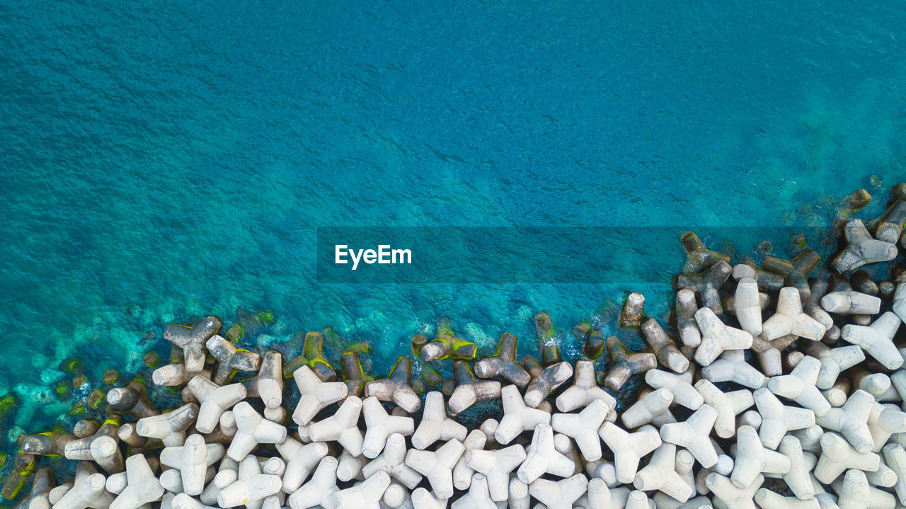 Aerial view of tetrapods by sea