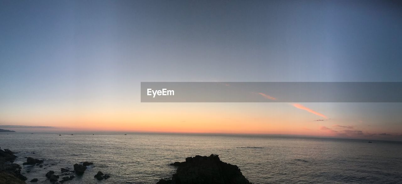 SCENIC VIEW OF SUNSET OVER SEA