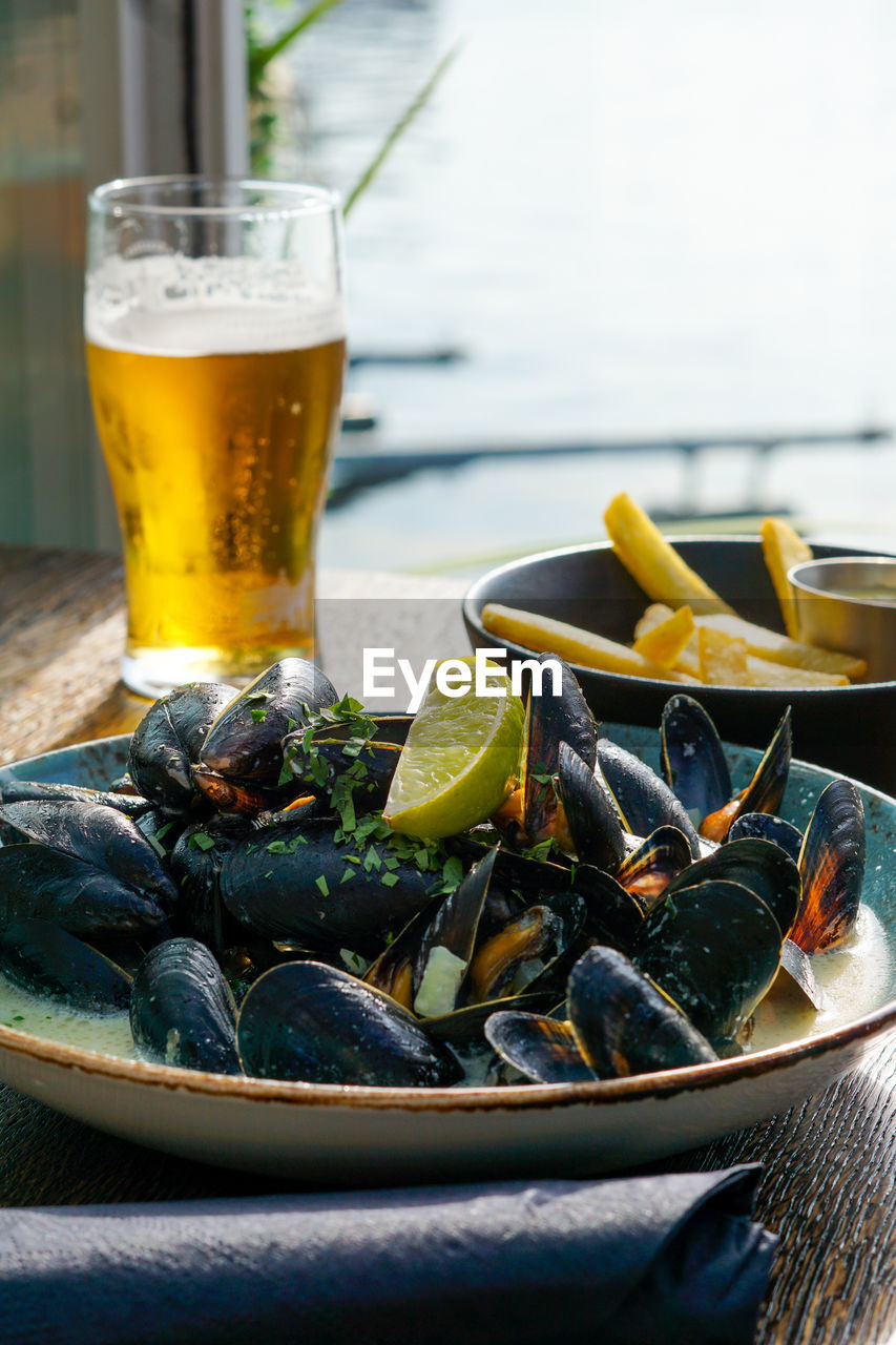 Close up of seafood and drink on table at restaurant