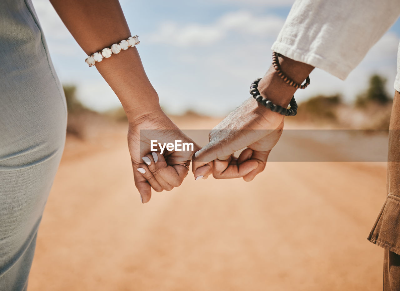midsection of woman holding hands