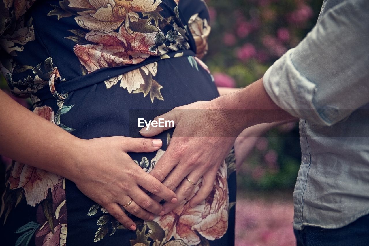 Man touching belly of pregnant woman
