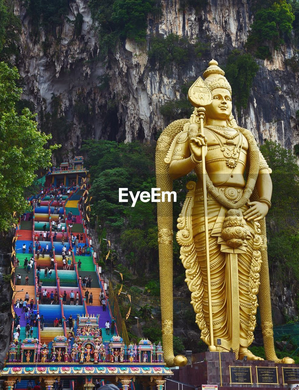 STATUE AGAINST TEMPLE BUILDING