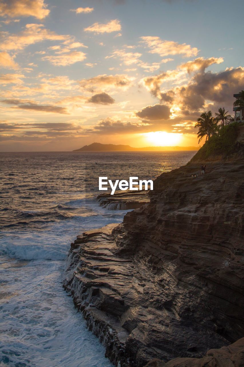 Scenic view of beach against sky during sunset