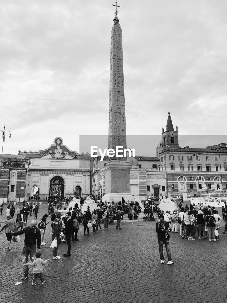 TOURISTS LOOKING AT EIFFEL TOWER IN CITY