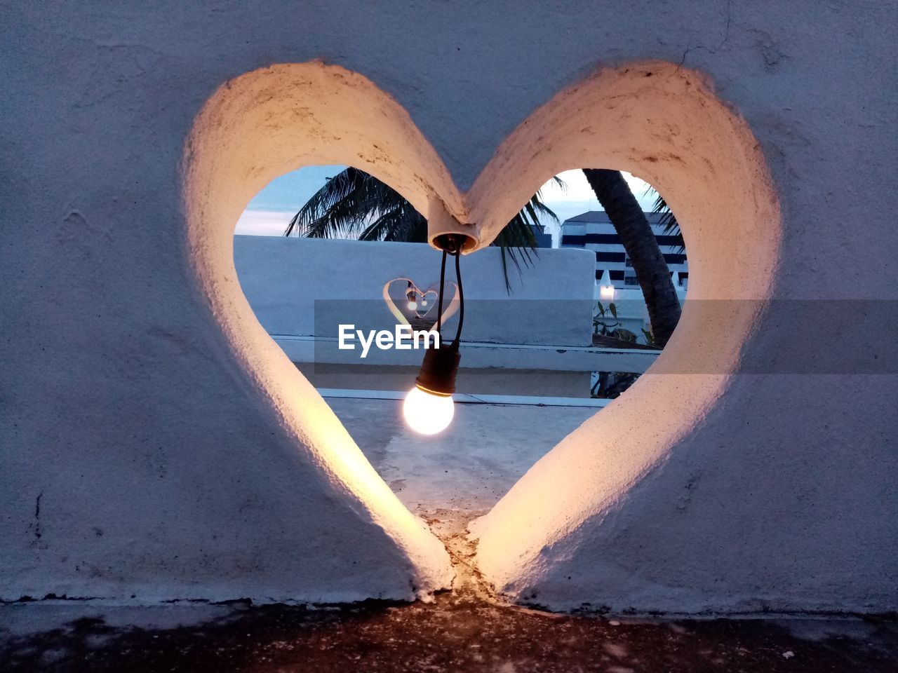 REFLECTION OF ILLUMINATED BUILDING IN MIRROR