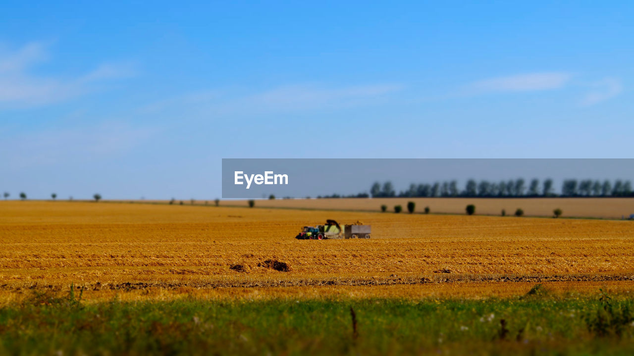 Tractor on field against sky