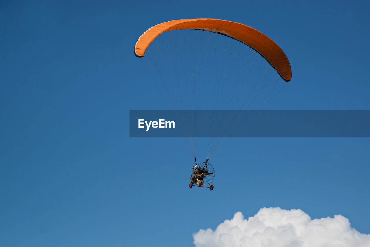 LOW ANGLE VIEW OF PARAGLIDING FLYING AGAINST SKY