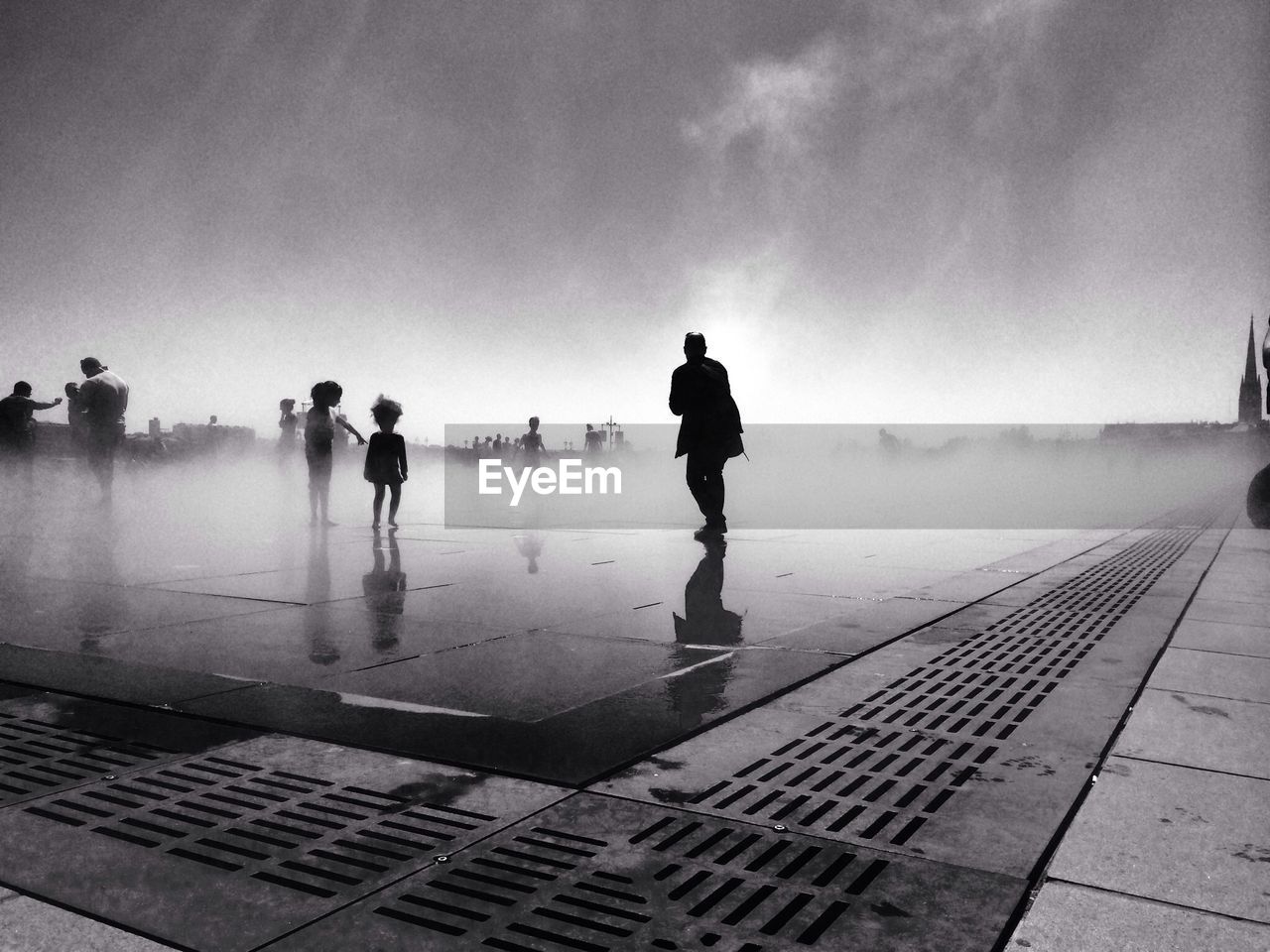 Silhouette people at fountain