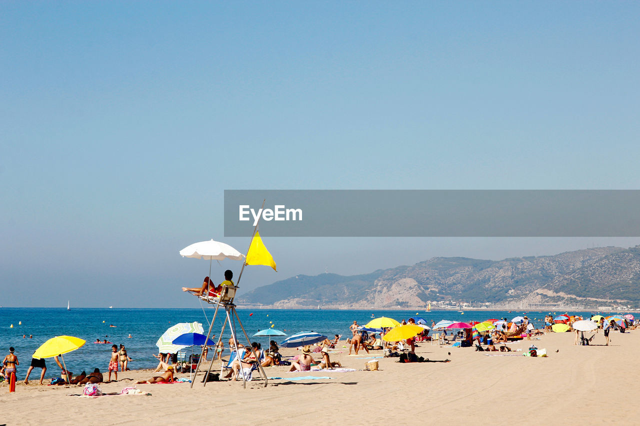 People on beach against sky