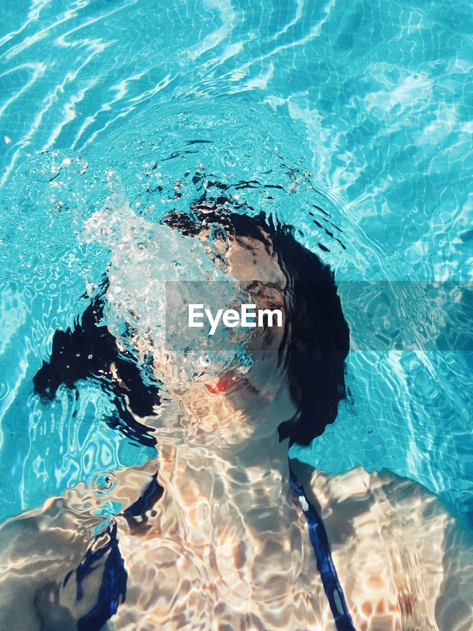 High angle view of woman swimming in pool