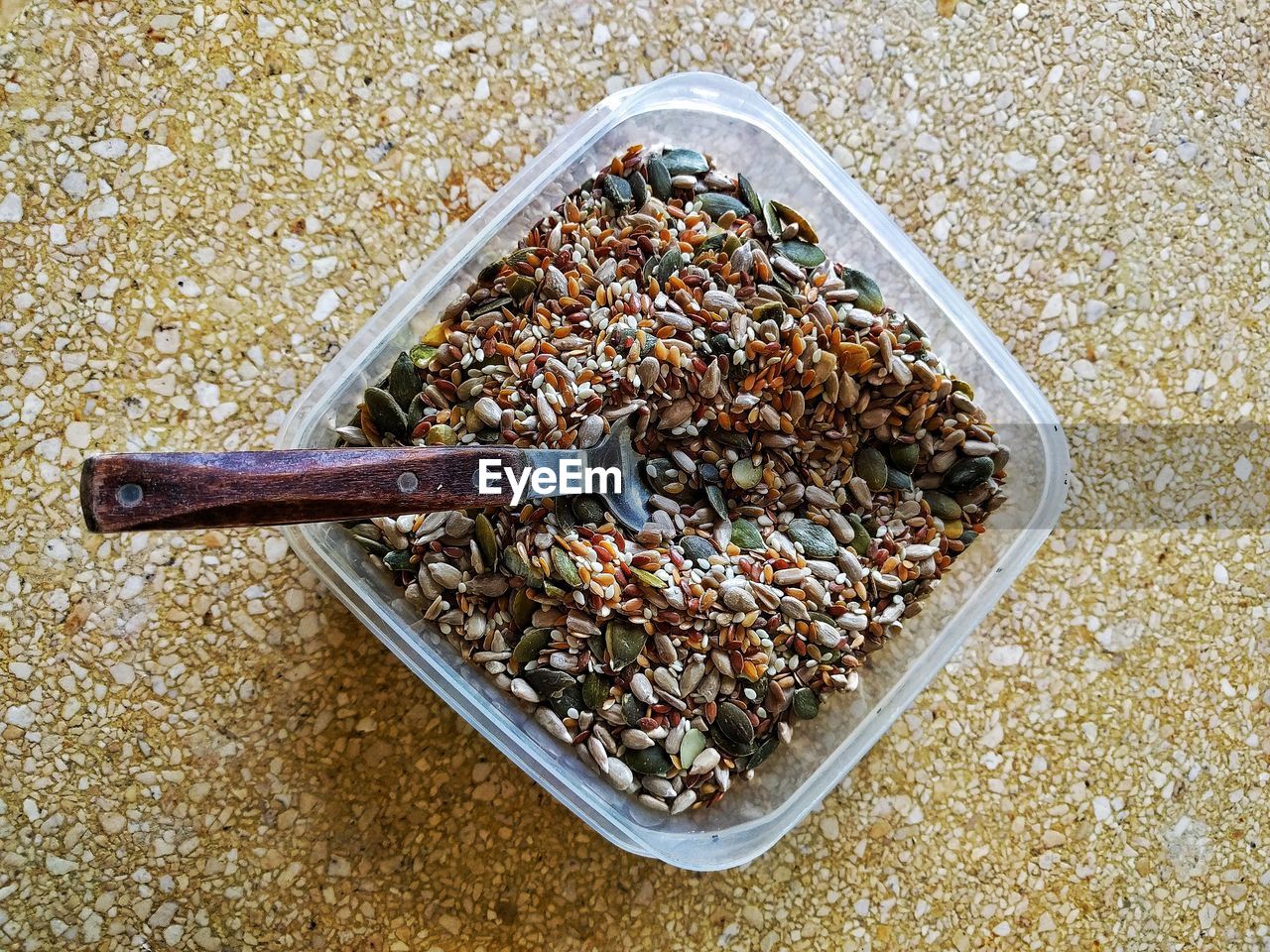 Directly above shot of seeds in plastic container