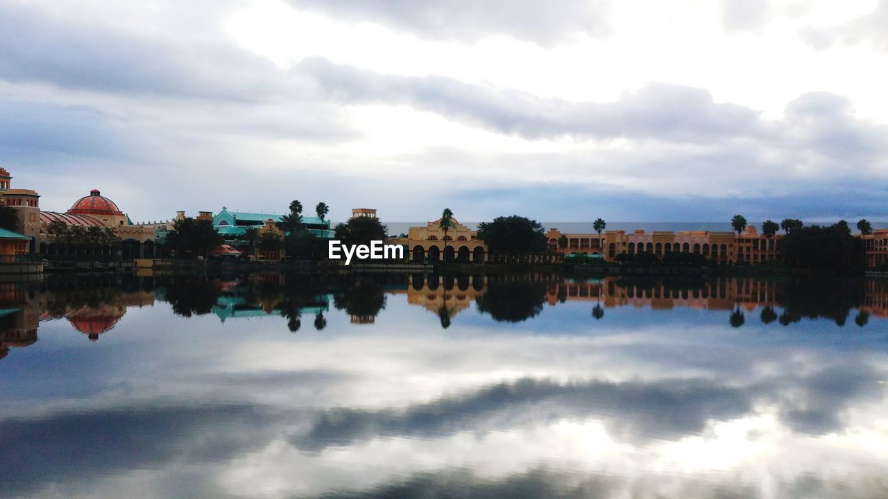 REFLECTION OF BUILDINGS IN CITY AGAINST SKY