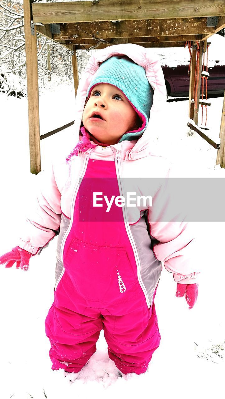 CUTE GIRL IN SNOW COVERED WITH PINK FACE