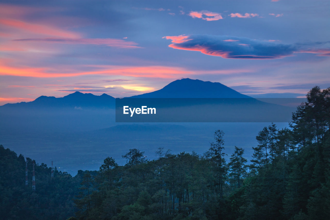 Scenic view of silhouette mountains against sky at sunset