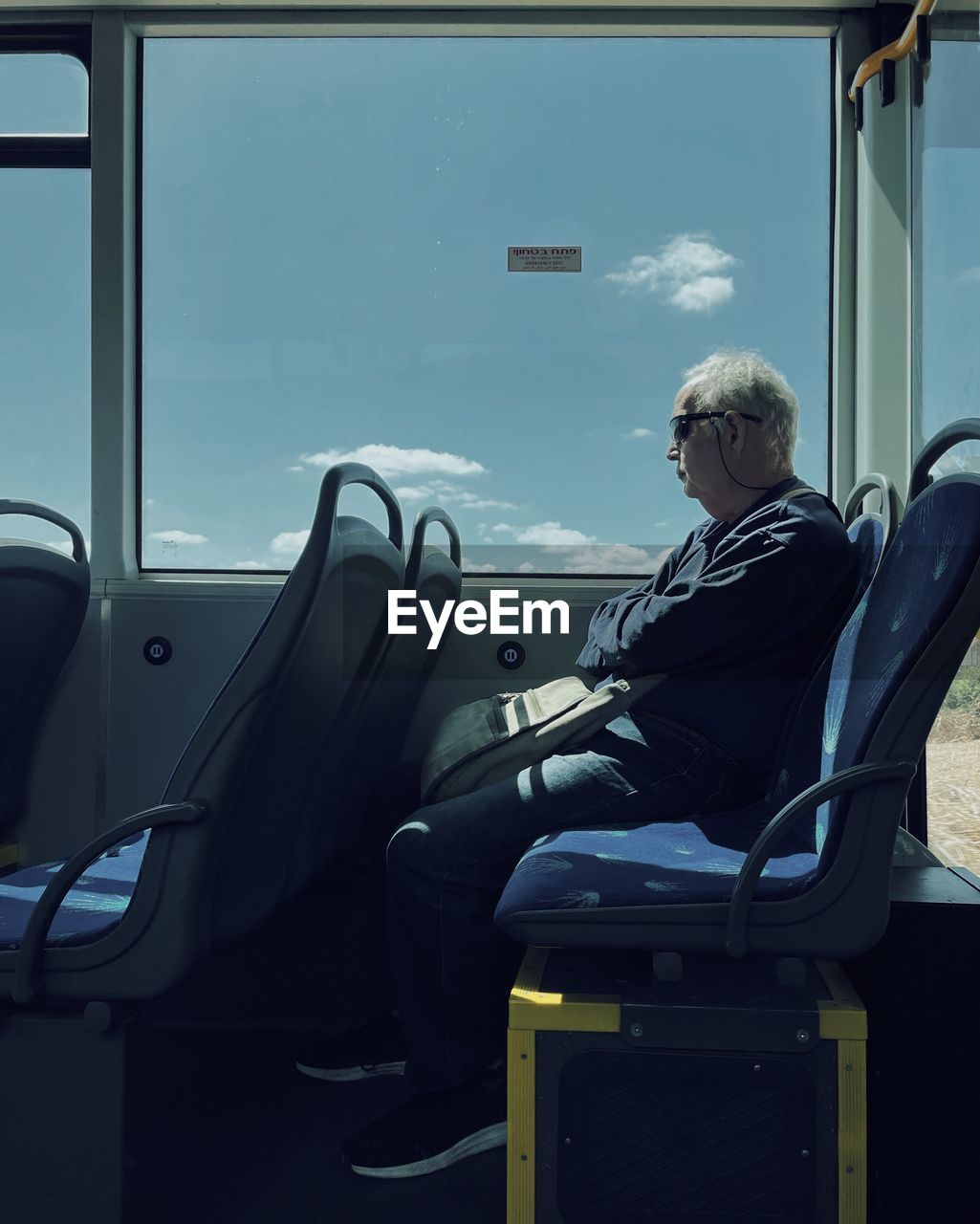 MIDSECTION OF MAN SITTING IN BUS