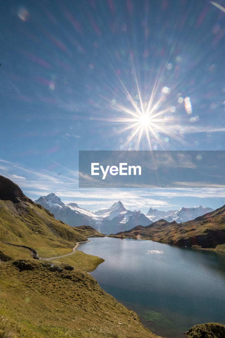 Sun shining over calm lake