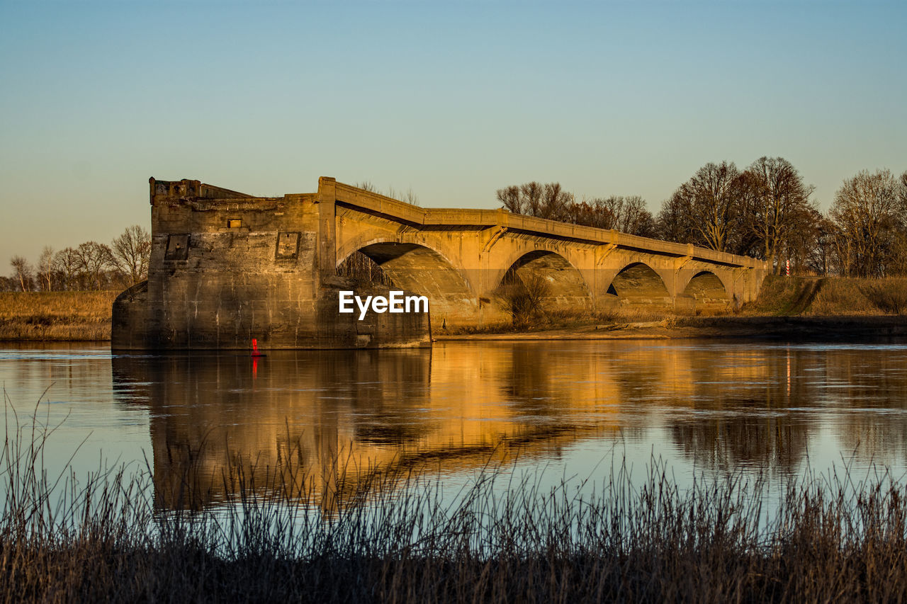 VIEW OF BRIDGE OVER RIVER AGAINST CLEAR SKY