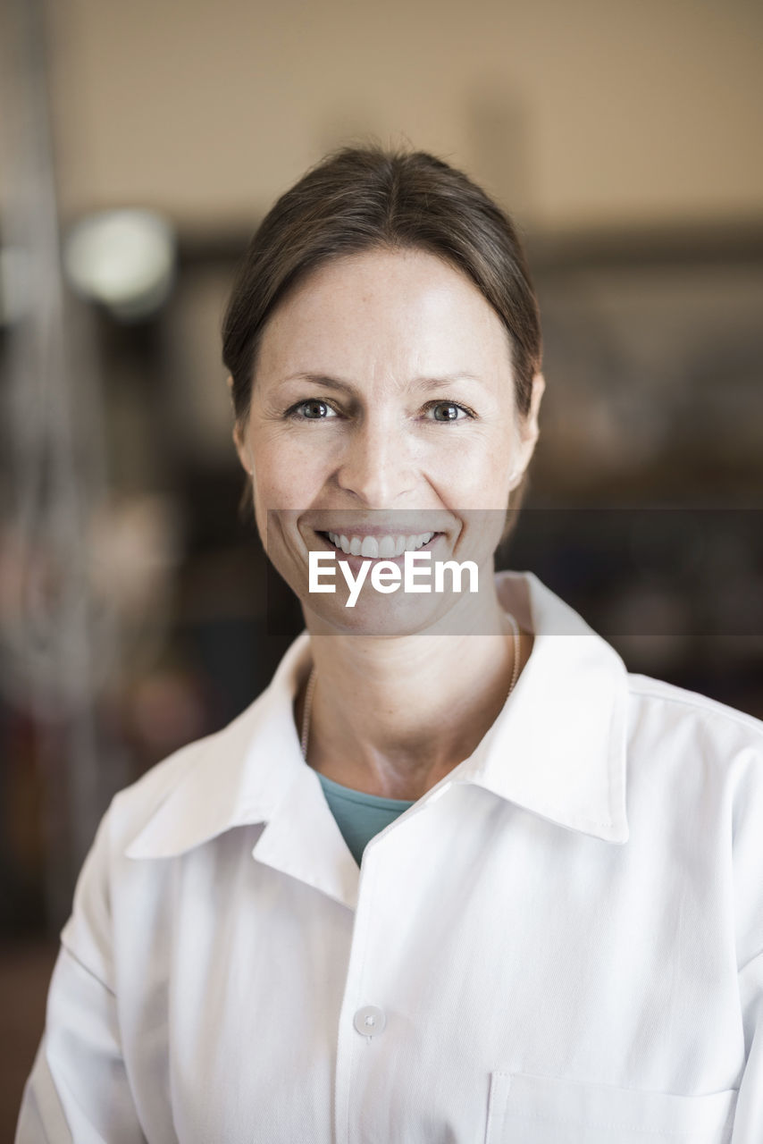 Portrait of confident engineer smiling in manufacturing industry