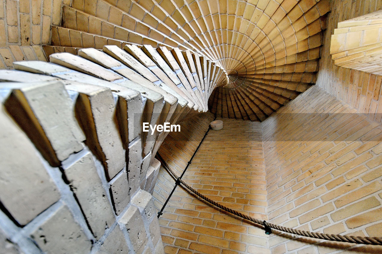 Low angle view of spiral staircase in old church