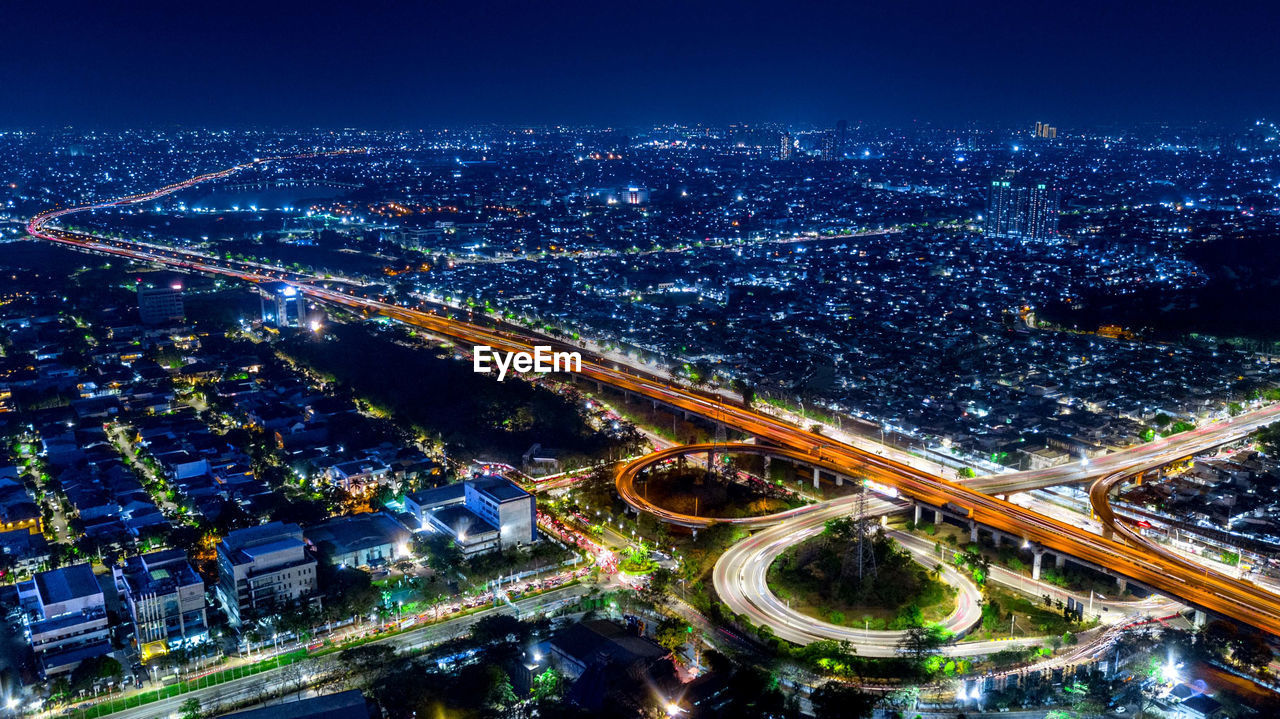 High angle view of illuminated city street at night