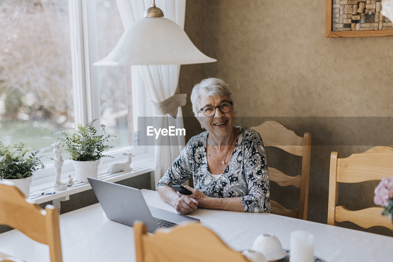 Senior woman sitting at dining table