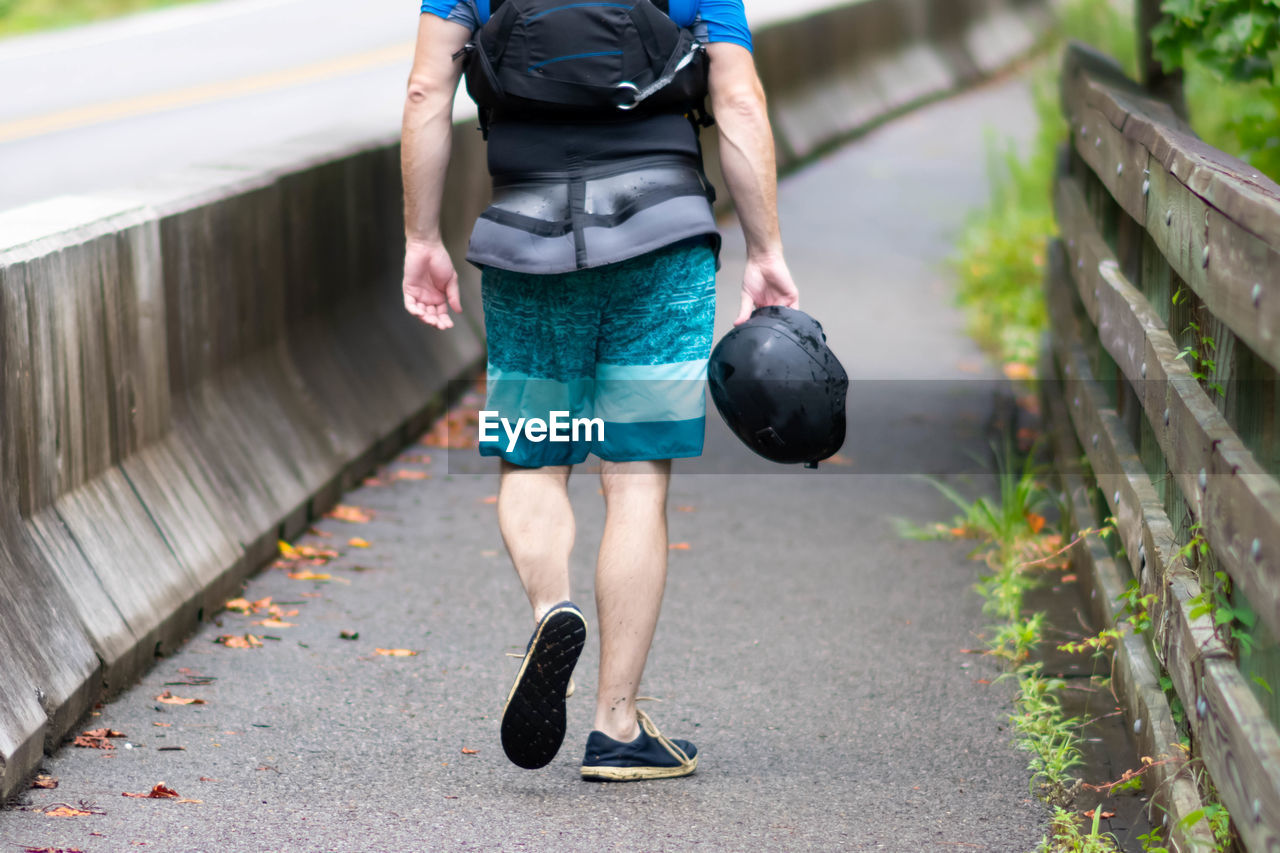 Low section of man walking on footpath