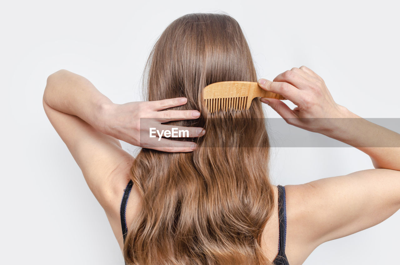 Rear view of woman against white background