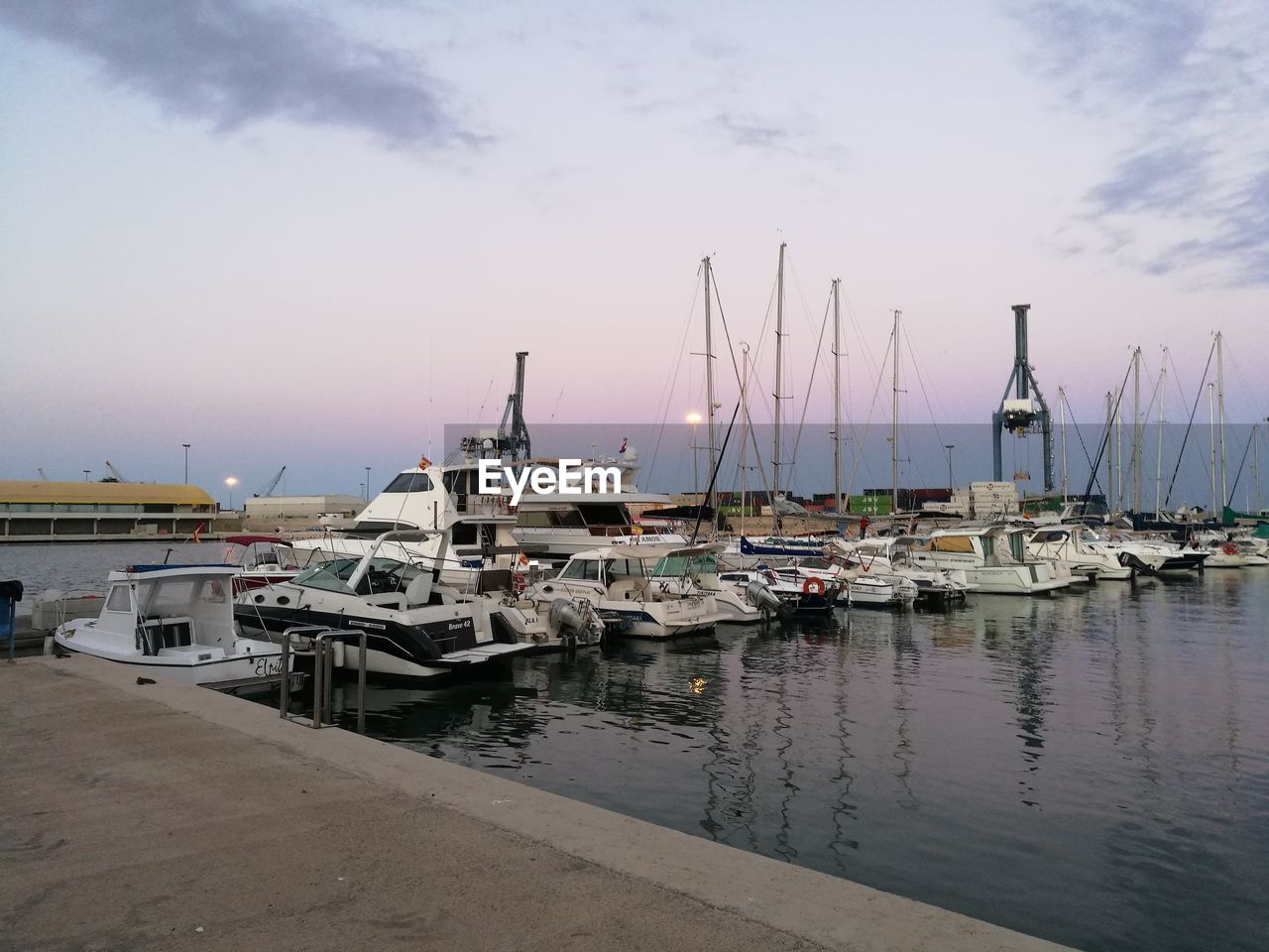 SAILBOATS MOORED IN SEA AGAINST SKY