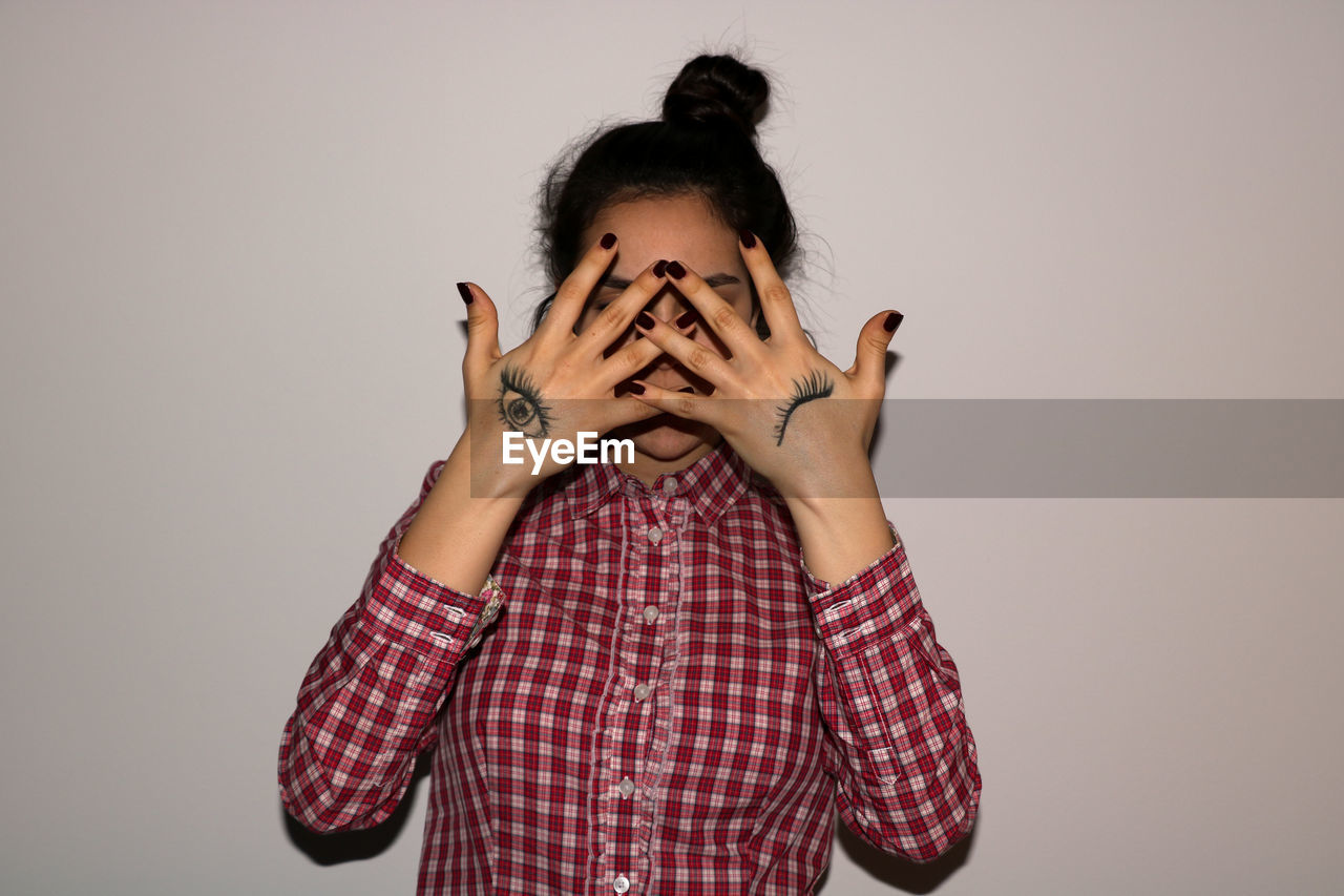 Close-up of a woman covering face