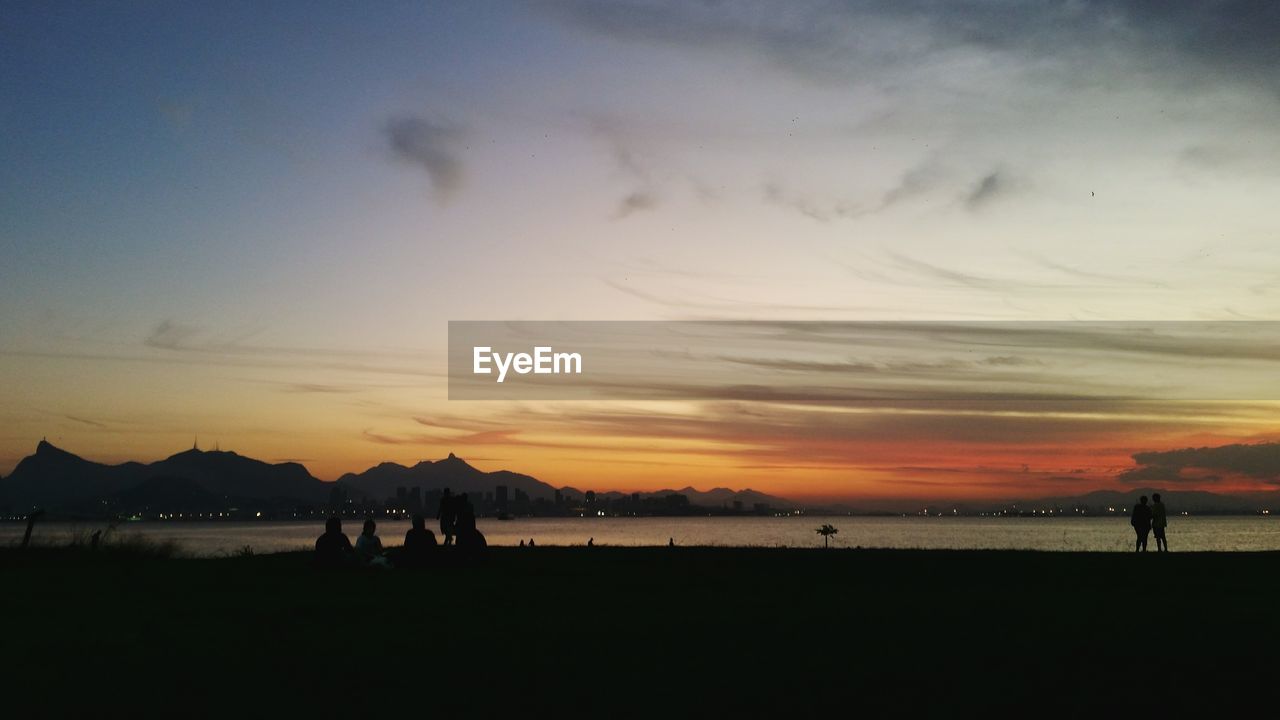 People on beach at sunset