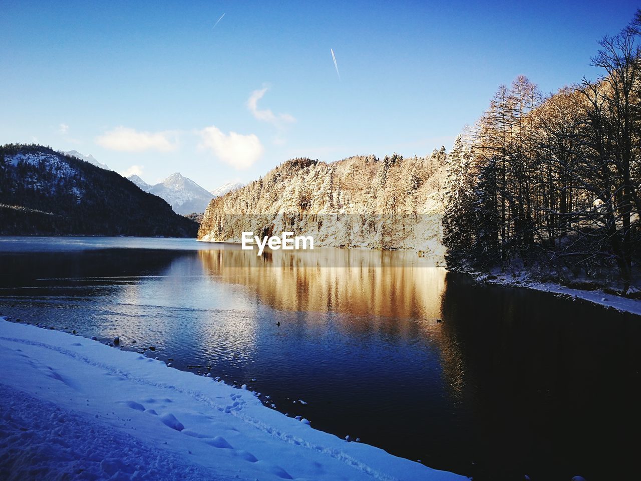 Scenic view of lake and mountains against sky