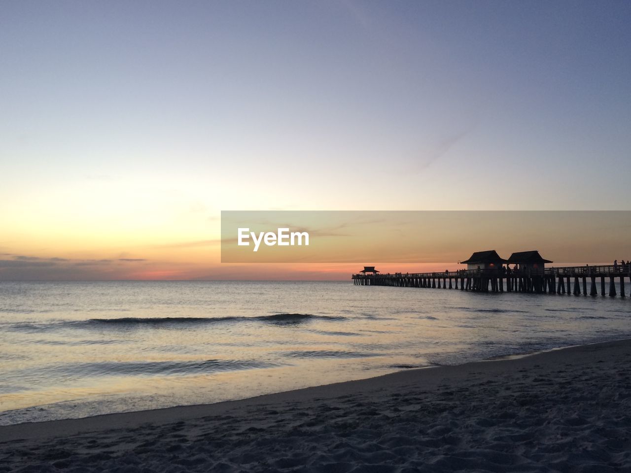 Scenic view of beach against sky during sunset